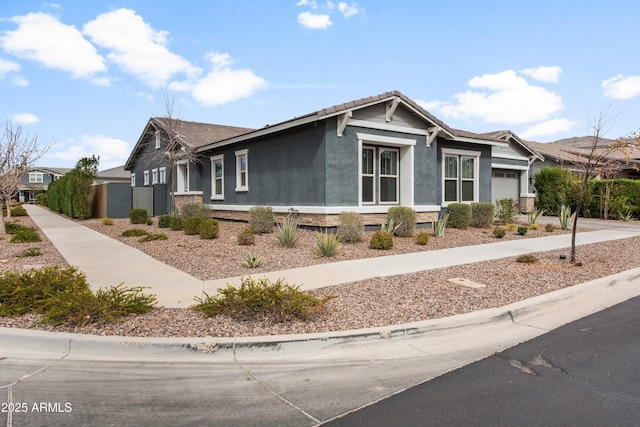 view of side of home with a garage and stucco siding