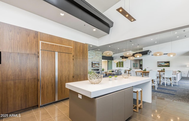 10322 E Topaz Ave, Mesa, AZ 85212 - kitchen featuring light tile patterned floors, modern cabinets, light countertops, a towering ceiling, and open floor plan