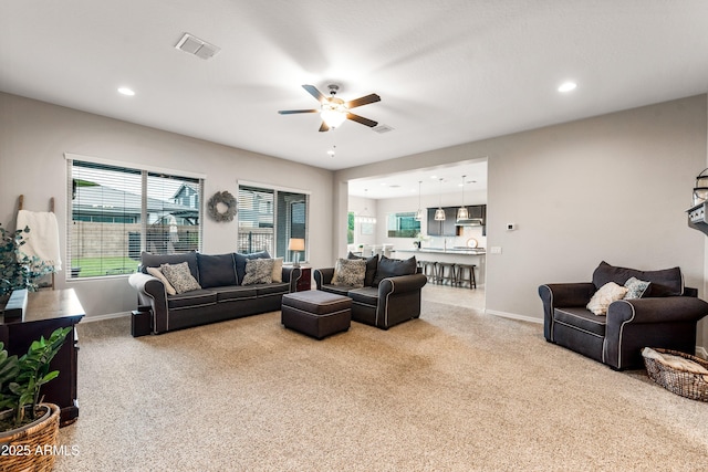 living area with carpet, visible vents, baseboards, and recessed lighting