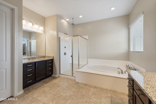 full bathroom featuring a stall shower, a garden tub, vanity, and tile patterned floors