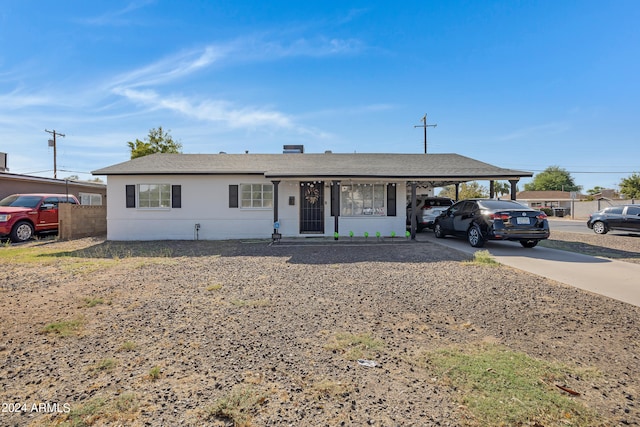 ranch-style house with a porch and a carport