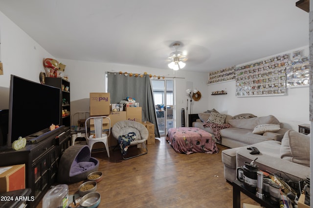 living room featuring hardwood / wood-style floors and ceiling fan