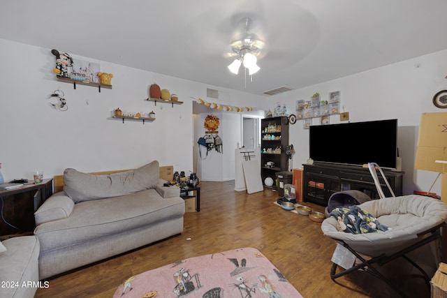 living room featuring wood-type flooring and ceiling fan