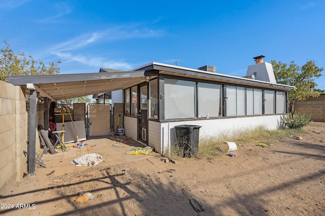 back of house with a carport