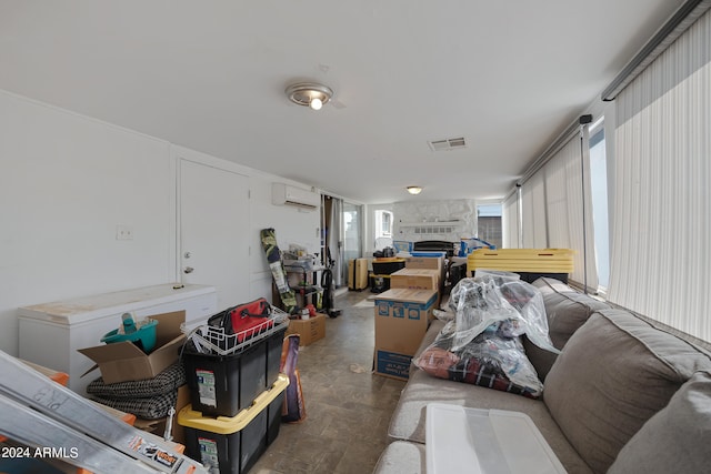 living room with a fireplace and an AC wall unit