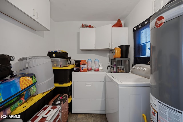 clothes washing area featuring cabinets, independent washer and dryer, and water heater