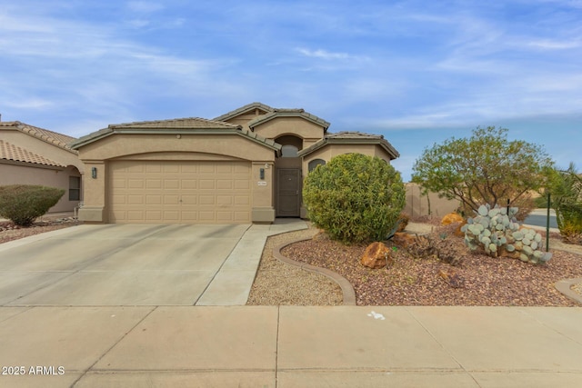 view of front of property with a garage, a tiled roof, concrete driveway, and stucco siding