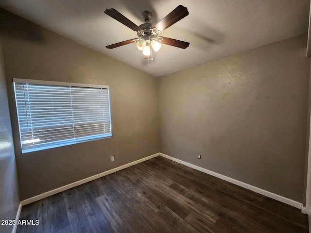 unfurnished room with ceiling fan, dark hardwood / wood-style flooring, and lofted ceiling