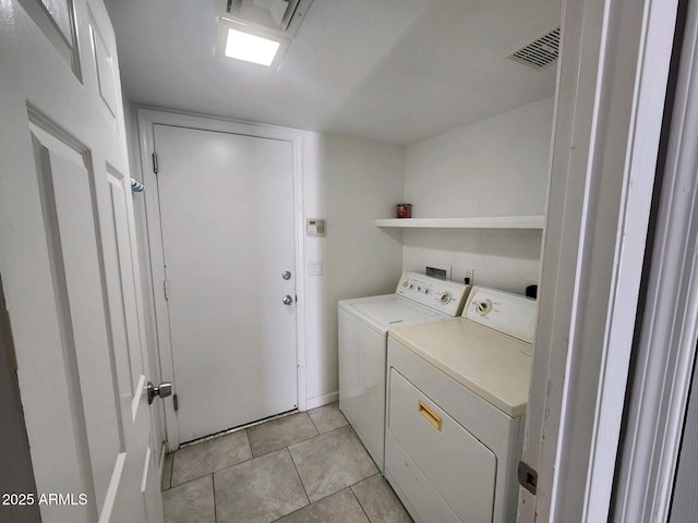 washroom featuring light tile patterned floors and washing machine and dryer