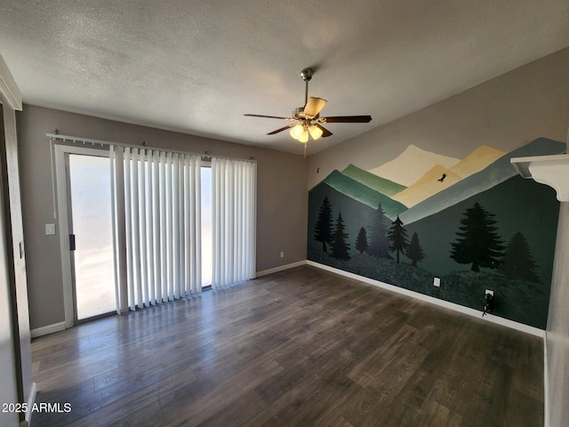 spare room featuring ceiling fan, dark hardwood / wood-style flooring, and a textured ceiling