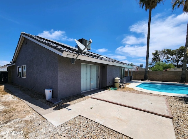 back of house featuring a patio area and a fenced in pool