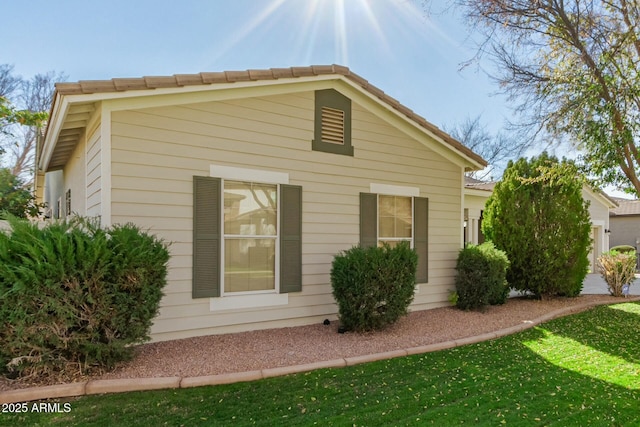 view of side of home with a lawn