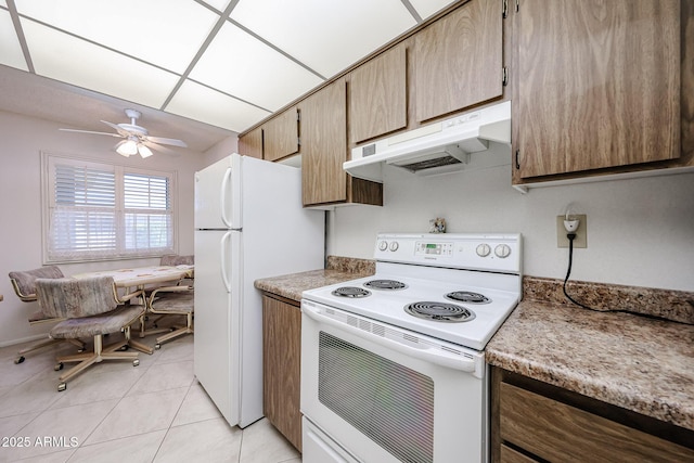 kitchen featuring ceiling fan, light tile patterned floors, and white appliances