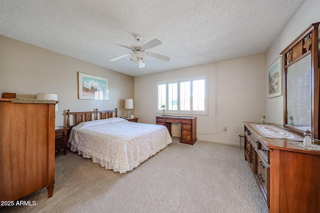 carpeted bedroom featuring ceiling fan and a textured ceiling