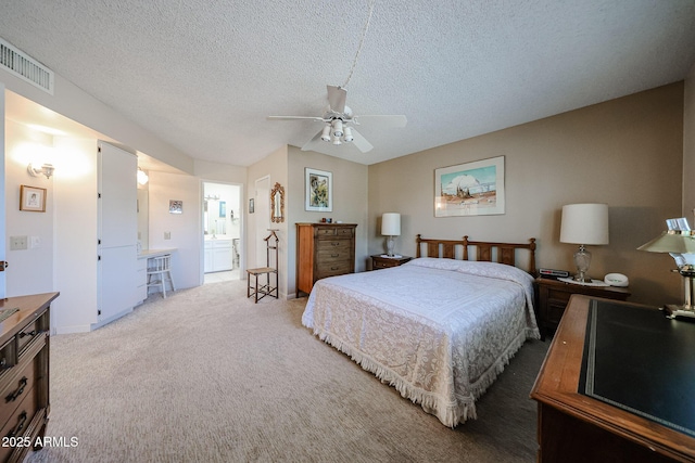 carpeted bedroom featuring connected bathroom, a textured ceiling, and ceiling fan