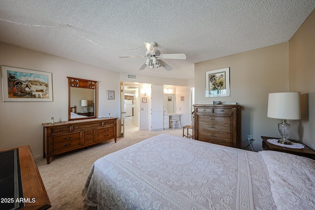 bedroom featuring white refrigerator, ceiling fan, light carpet, and a textured ceiling