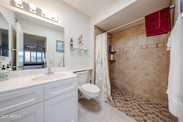 bathroom with tile patterned flooring, vanity, walk in shower, ceiling fan, and toilet