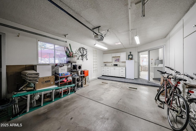 garage featuring a garage door opener and white fridge