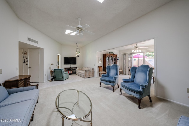 living room with light carpet, ceiling fan, and a skylight