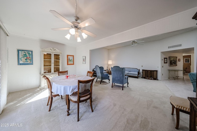 dining room featuring crown molding, ceiling fan, and light carpet