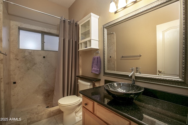 bathroom featuring vanity, a shower with curtain, tile patterned floors, and toilet