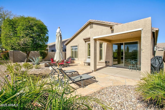 rear view of property featuring a patio