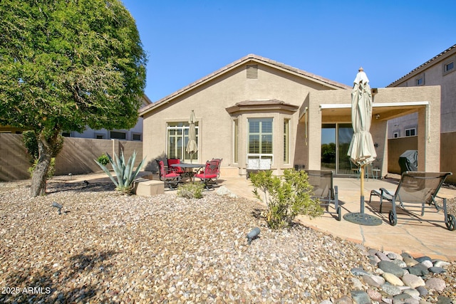 back of house with a patio