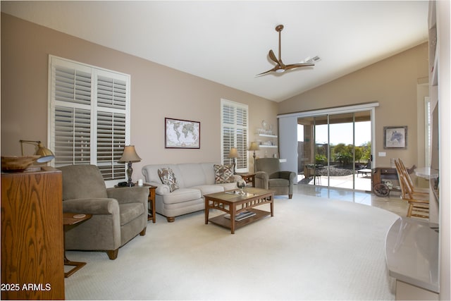 living room featuring light carpet, vaulted ceiling, and ceiling fan