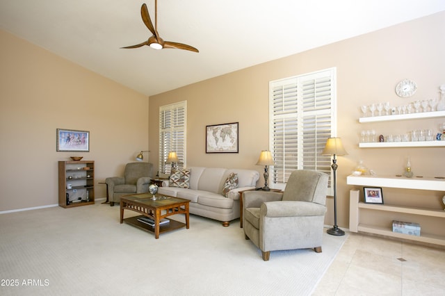 living room featuring ceiling fan, carpet flooring, and vaulted ceiling