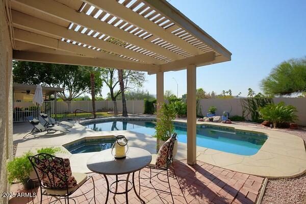 view of pool with an in ground hot tub, a pergola, and a patio area