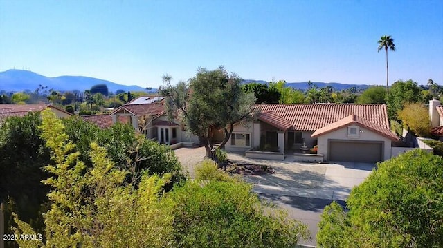 view of front of property featuring a mountain view and a garage