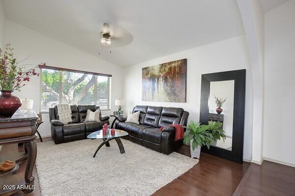 living room featuring vaulted ceiling, dark hardwood / wood-style floors, and ceiling fan