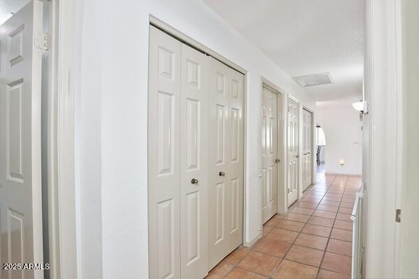 corridor featuring light tile patterned floors