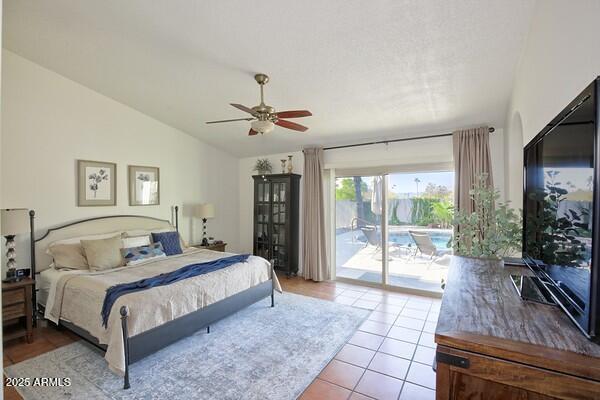 tiled bedroom with lofted ceiling, access to exterior, and ceiling fan