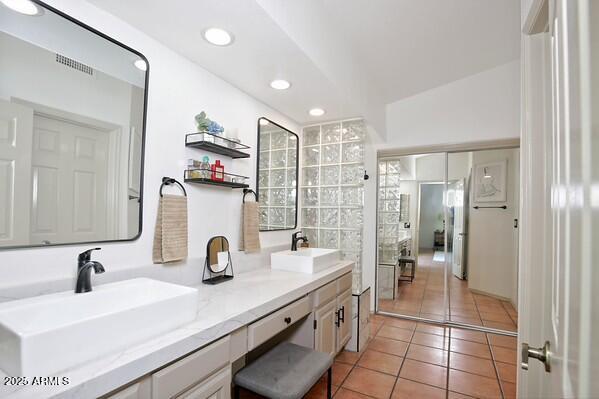 bathroom with tile patterned flooring and vanity