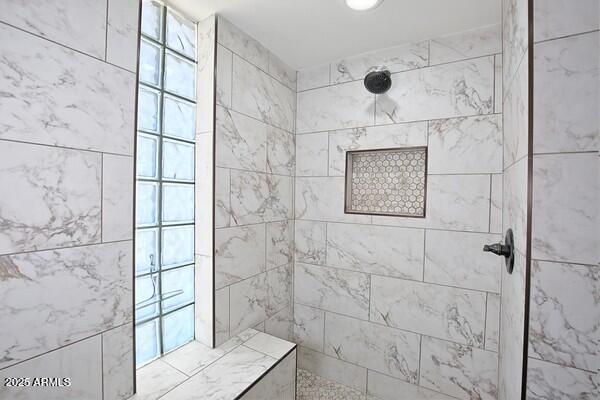 bathroom with a tile shower