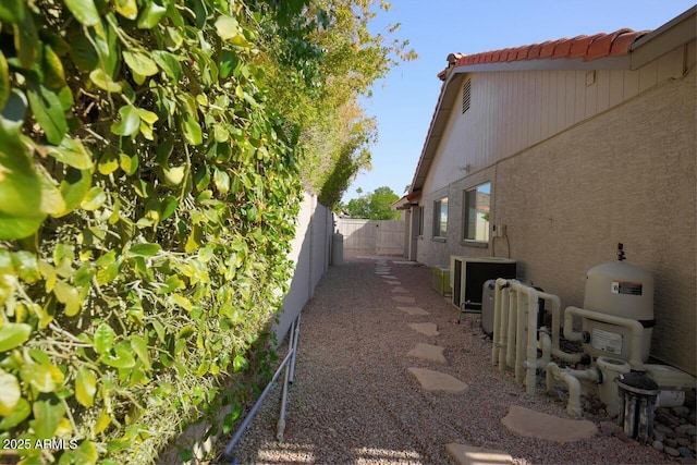 view of side of property with central air condition unit