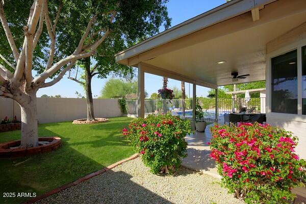 view of yard with ceiling fan