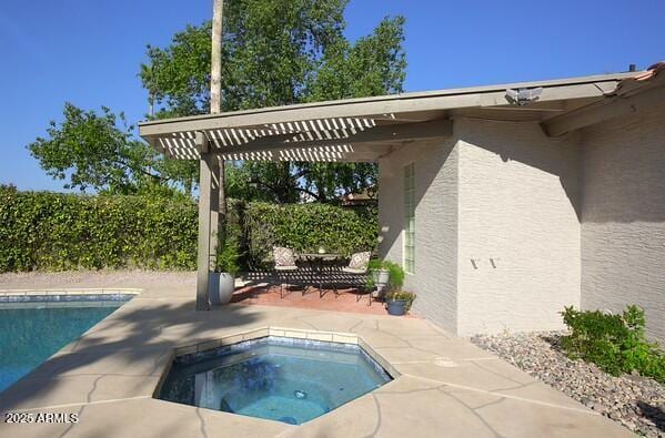 view of pool with an in ground hot tub and a patio