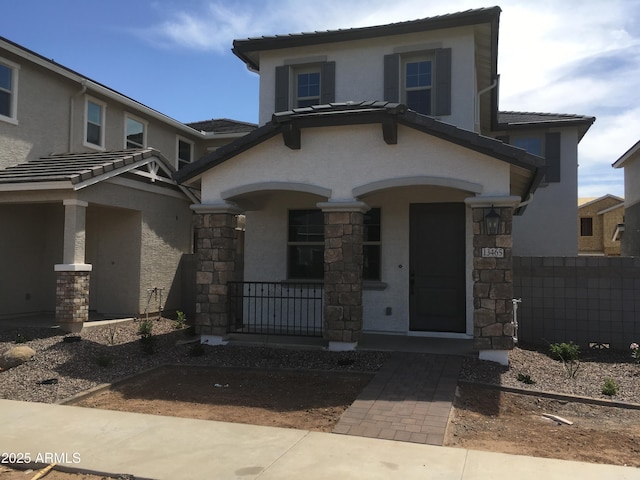 13498 N 156th Dr, Surprise, AZ 85379 - view of front facade with covered porch, stucco siding, a tiled roof, and stone siding