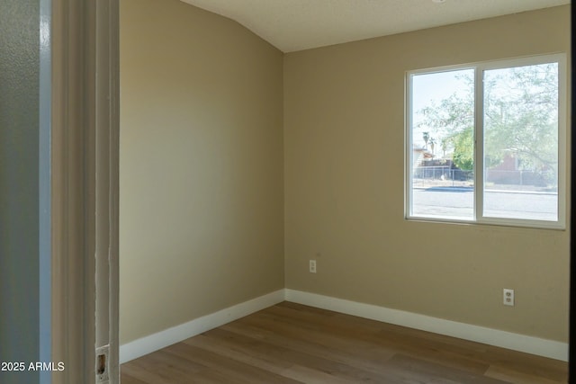 empty room featuring baseboards and wood finished floors