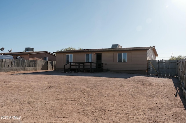 back of property featuring a wooden deck, central air condition unit, and a fenced backyard