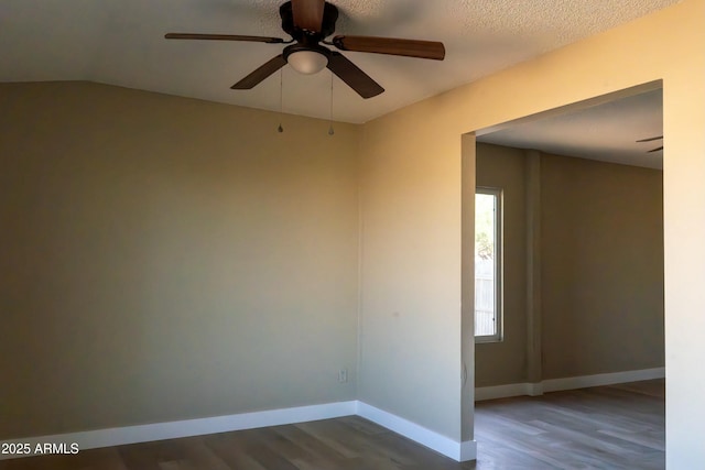 unfurnished room featuring ceiling fan, baseboards, and dark wood-style flooring