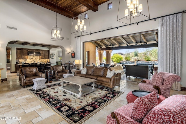 living room with wooden ceiling, beam ceiling, light tile flooring, and an inviting chandelier