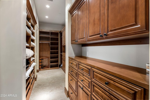 spacious closet with light tile floors