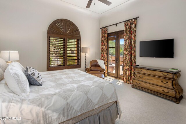 carpeted bedroom with ceiling fan, access to exterior, and multiple windows