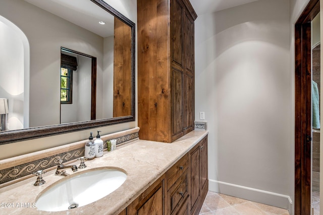 bathroom with double sink, tile floors, and oversized vanity