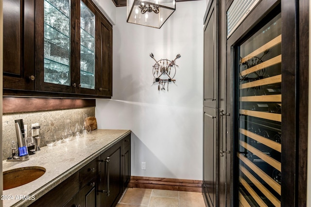 bathroom with a wealth of natural light, tile flooring, tasteful backsplash, and beverage cooler