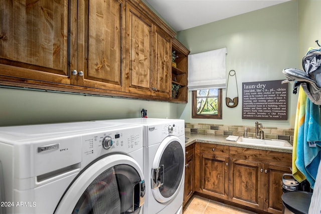 laundry room with light tile floors, cabinets, sink, and washer and dryer