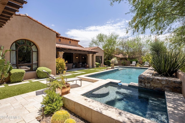 view of pool with a patio area and an in ground hot tub